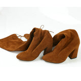 leather women shoes on knee